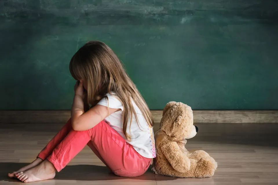 Caregiver comforting a child during a difficult moment