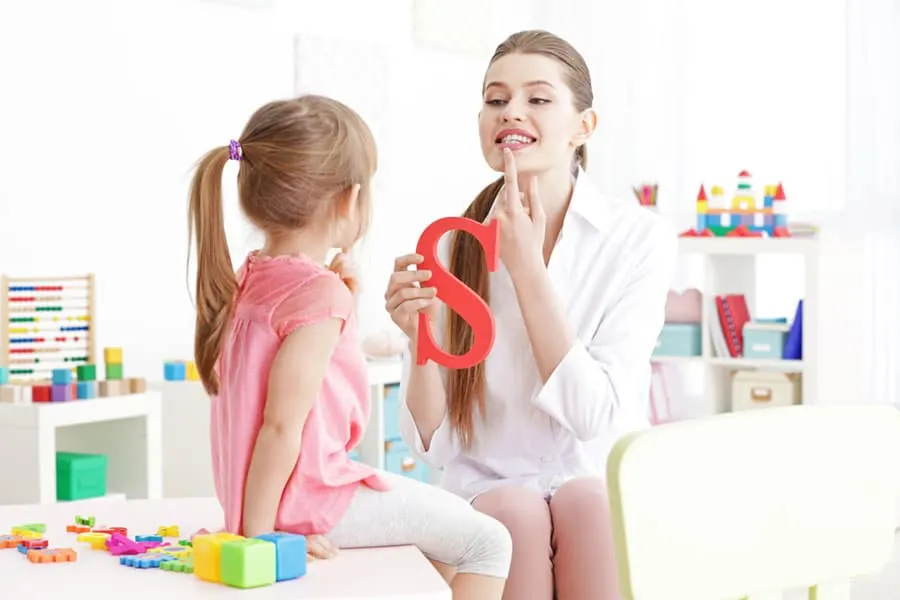 Adult helping a child practice speech sounds